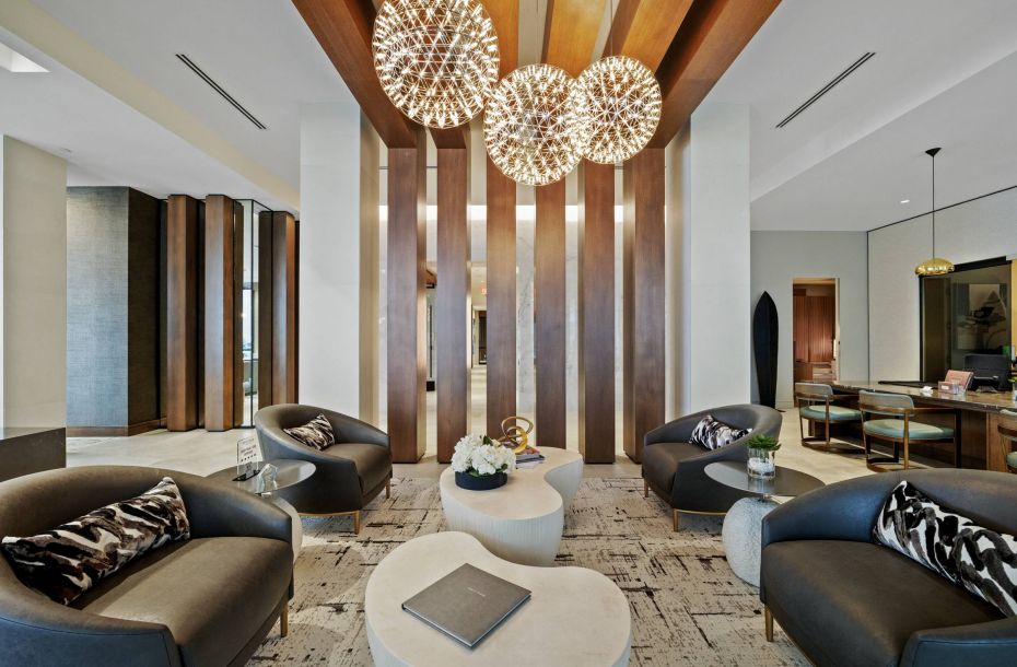Hanover Company, Hanover Toscana Modern lounge with four chairs, round tables, wooden panels, and decorative pendant lights.