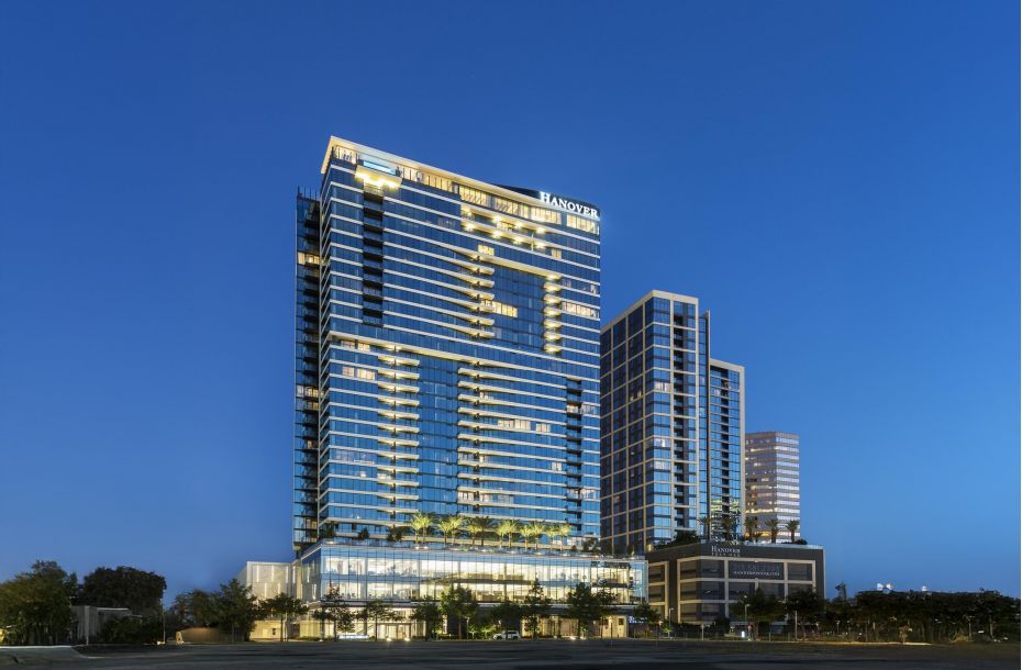 Modern high-rise building illuminated at night with clear sky backdrop.